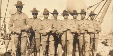 Historic group of early U.S. Marines standing in formation with rifles during training period photograph