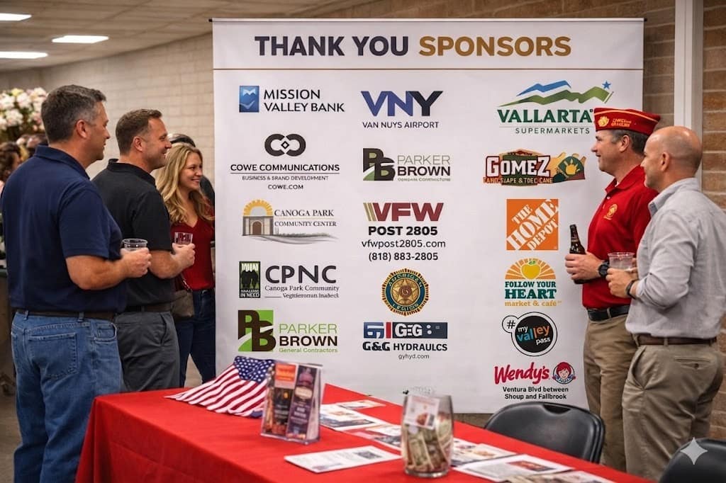 Sponsor banner displayed at an event with members interacting nearby